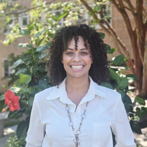 Picture is of Carlie, standing outside, smiling.