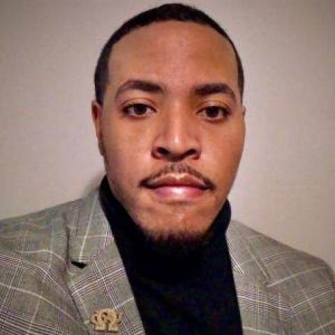 Profile headshot photo of Dominic Carter, JD.