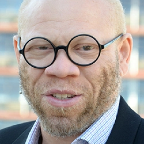 Profile headshot photo of Raimi Gbadamosi.