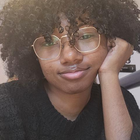 Profile headshot photo of Raven Y. Sanders, MLIS.