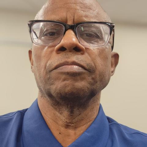 Profile headshot photo of Rossini C. Clark.