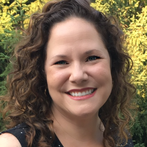 headshot of Samantha Rae Powers with green foliage background