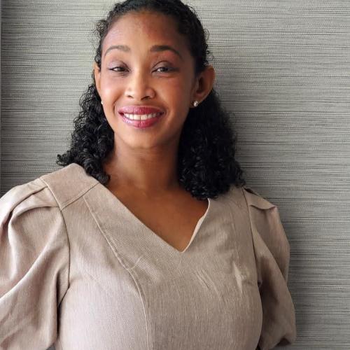 Biracial woman, with short curly hair in a Tan Dress