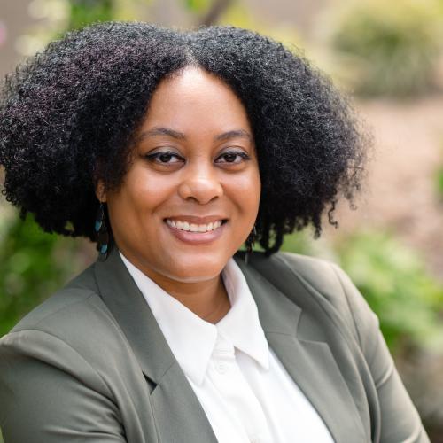 Pictured here is Dr. Sabrina Evans, wearing a white blouse and green blazer.