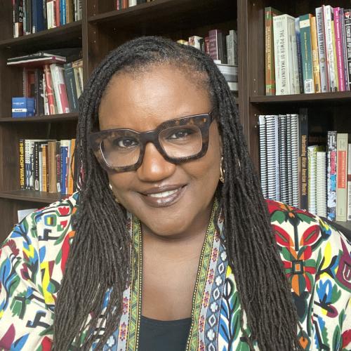 Photo of Shantay Robinson in front of a bookcase