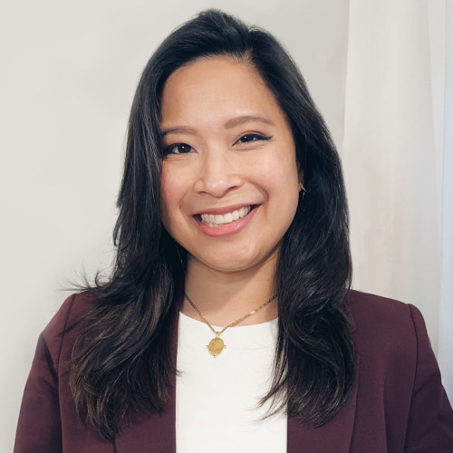 Woman with long hair red blazer and white blouse