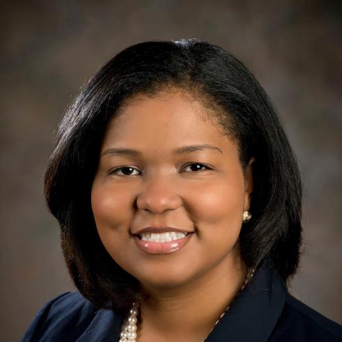 Lakia Young wearing a black blazer and gold necklace.