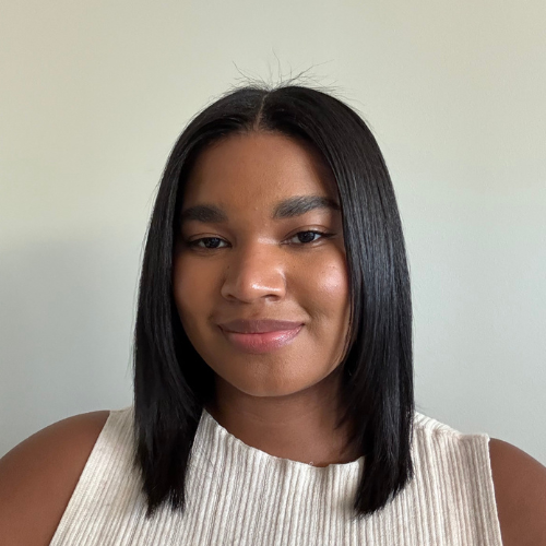 Black woman with straigh black hair smiling softly