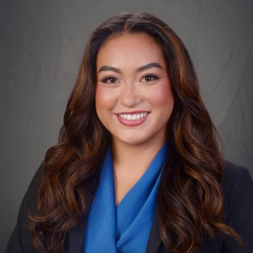 Kate Amistoso smiling for a professional headshot.