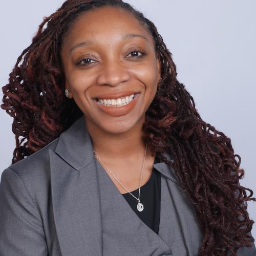 Picture of Prof.essor Jamille Fields Allsbrook looking at the camera and smiling.